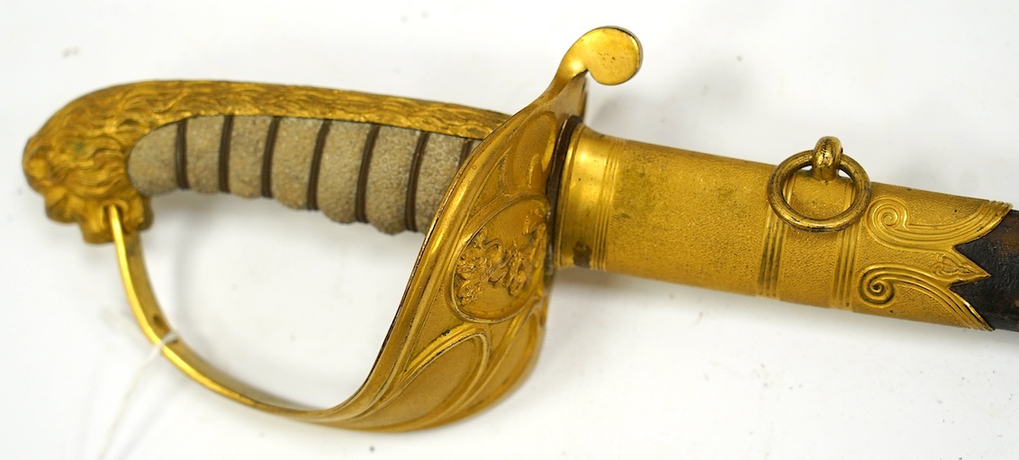 An East India Company naval officer's sword, blade by H. Wart, etched with East India Company device and foliage, regulation gilt, brass hilt with EIC device, white fish skin covered grip, in its leather scabbard with gi